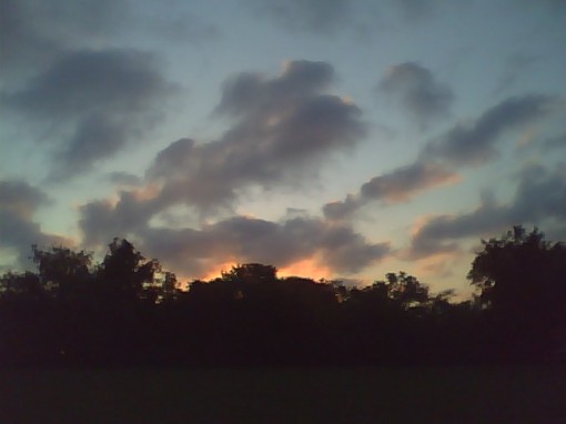 Morning's first light sets the clouds afire. Sorry, the cell phone camera just doesn't do it justice.